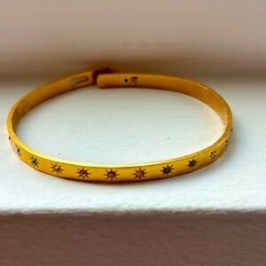 Madewell star glider bangle with multi colored gemstones in starburst pattern